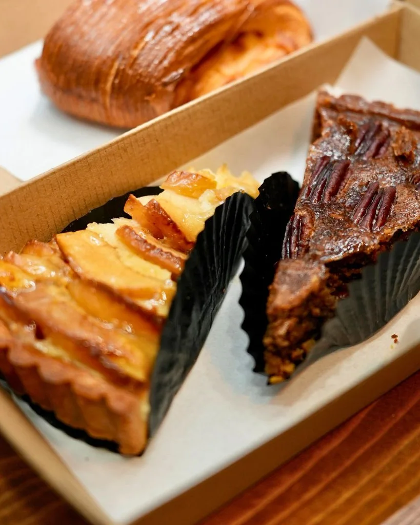 Umeshu apple tart and pecan tart boxed side by side at Wild Honey Pie